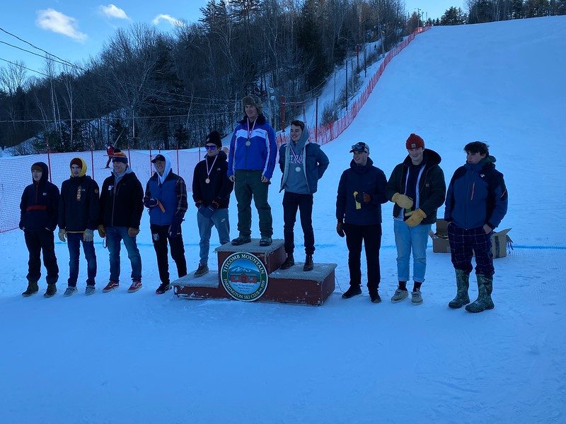 Camden Hills skiers Oscar Horovitz (far left) and Caellen Roberts (second from right) at the podium Feb. 8. (Courtesy Mike Smith)