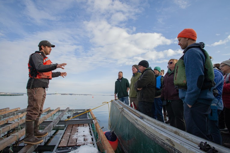 Matt Moretti (left) from Bangs Island Mussels takes ABD participants on a tour of his farm operations during the group’s annual Industry Day event in December. (Photo courtesy Island Institute)