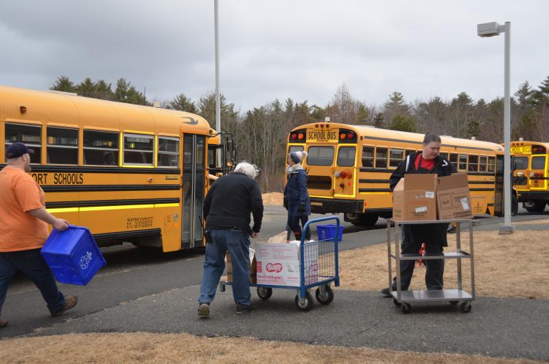 Staff get ready to load the buses.