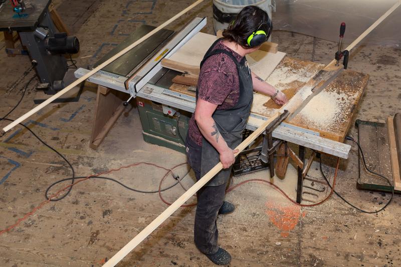 Emma is coving out the rub rails for the Mary Lacy using the table saw. This is one of the final steps in the Susan Skiff build. (Photo by Erin Tokarz)