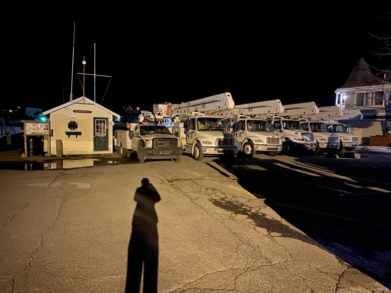 Crews from power companies from the Maritimes and other states take a rest Saturday night on the Public Landing in Camden. (Photo courtesy Alison McKellar)