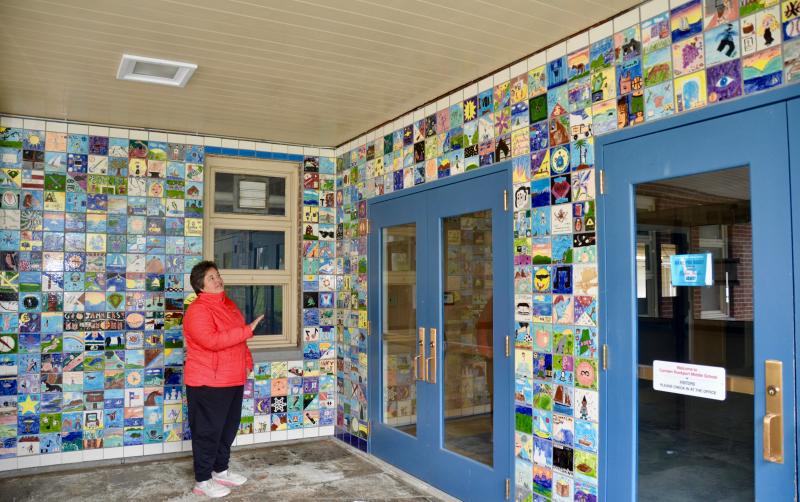 Maria Lib by, Camden-Rockport school superintendent, stands in the entry way to the Camden-Rockport Middle School, May 10. The school, scheduled for demolition in early June, is adorned with hand-crafted tiles made by students in art class over the past 20 years. The tiles are not to be saved; however, photos have been taken of each one, individually, and Libby said the hope is to present them in a new form, somewhere on the middle school’s Knowlton Street campus, which includes a new school and the Mary E. Taylor building. (Photos by Lynda Clancy)