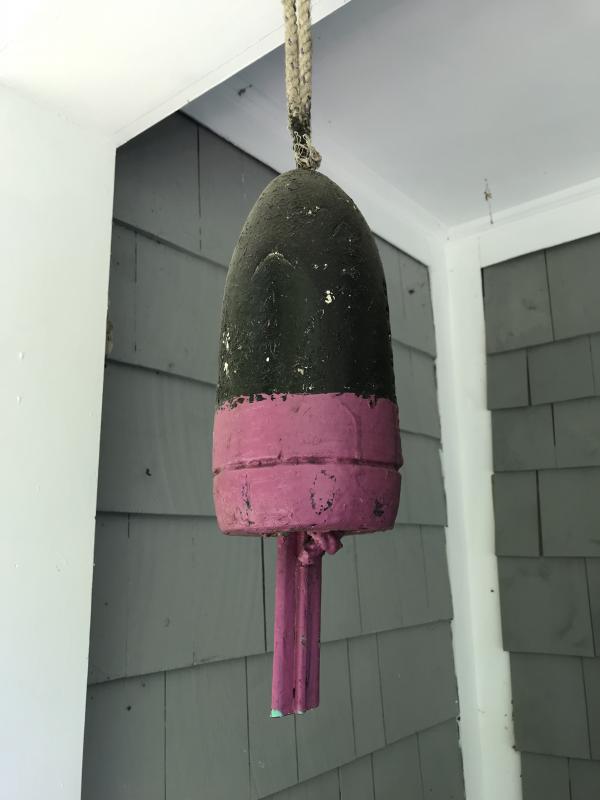 A buoy from Donald Drake’s collection of black and pink buoys had hung on his grave since he died in 2015. Someone took it 2020. (Photo courtesy Debra Drake)