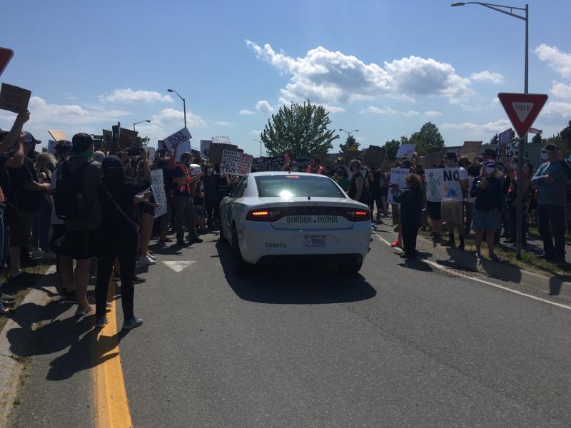 The border patrol’s attempt to drive through the crowd of protestors was met with a wall of humanity. (Photo courtesy Molly Mulhern)