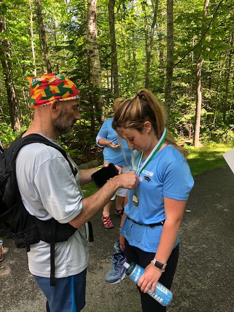 Abigail Nathan, right, receiving her medal for completing her half-marathon. (Courtesy Christine Nathan)