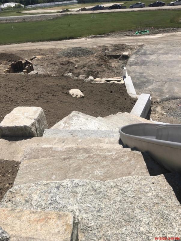 Granite steps from the lower level to the top of the stainless steel slide (see the slide’s curve right center). Also visible just above the center left side of the image is an area to hop from log top to log top. There are a lot of natural features in the playground design. (Photo courtesy Steve Claffie_