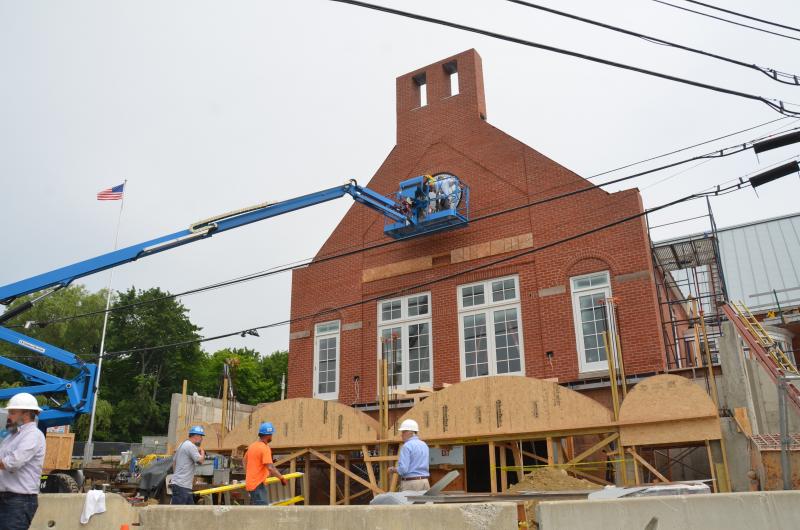 The new town clock is positioned into place at the Rockport Public Library in Rockport Village, July 23. (Photo by Lynda Clancy)