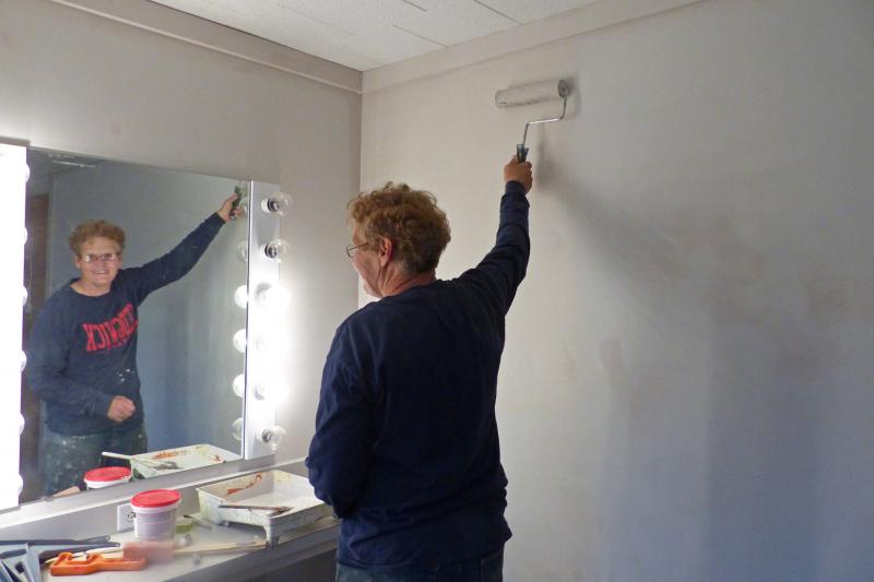 Painting dressing room (volunteer Bridget Hooper). (Photo courtesy of Waldo Theatre)