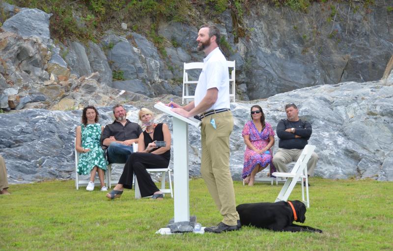 Mullins talks to a group of supporters who are scattered in a natural amphitheater on his Rockland quarry property. Seated to his right is campaign manager Marci Casas and treasurer Peter Overlock. (Photo by Lynda Clancy)