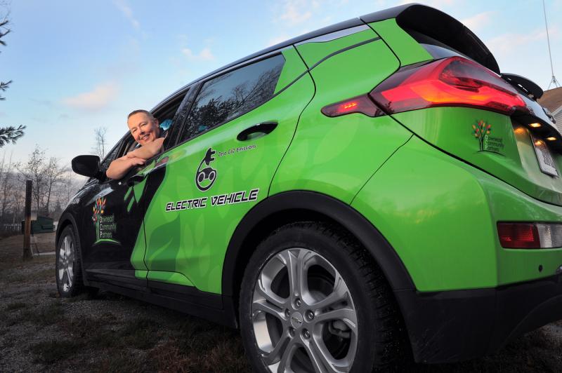 Dale Basher, housing operations manager for Downeast Community Partners, says electric vehicles can ease long-term cost burdens on Maine residents while providing environmental benefits. The Ellsworth-based nonprofit uses three all-electric Chevy Bolts to deliver food to impoverished people in Washington and Hancock counties. (Photo by Fred J. Field/Maine Monitor)