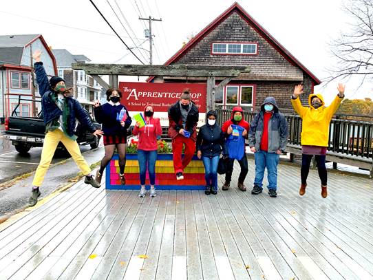 Artists and Project Interns jump for joy at the small outdoor celebration event held in late October. (Photo courtesy RSU 13 Adult & Community Education and Arts in Action)
