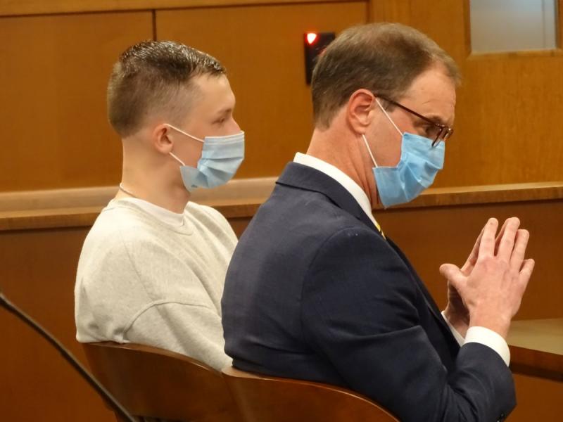 Austin McDevitt and his attorney, Rick Morse listen as McDevitt’s mother reads her statement. (photo by Erica Thoms)