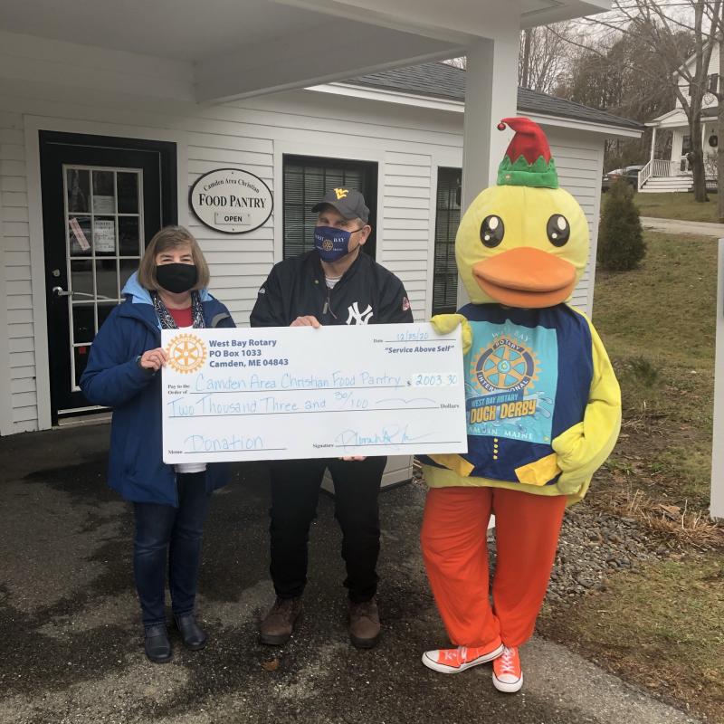 Lucky the Duck and West Bay Rotarian Ray Fink present a check to Camden Area Christian Food Pantry’s Board Vice President Debra Miliken. (Photo courtesy West Bay Rotary)