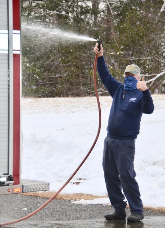 Don Fullington Jr., the Chief’s father, helps clean the new truck after it arrived from Brunswick.