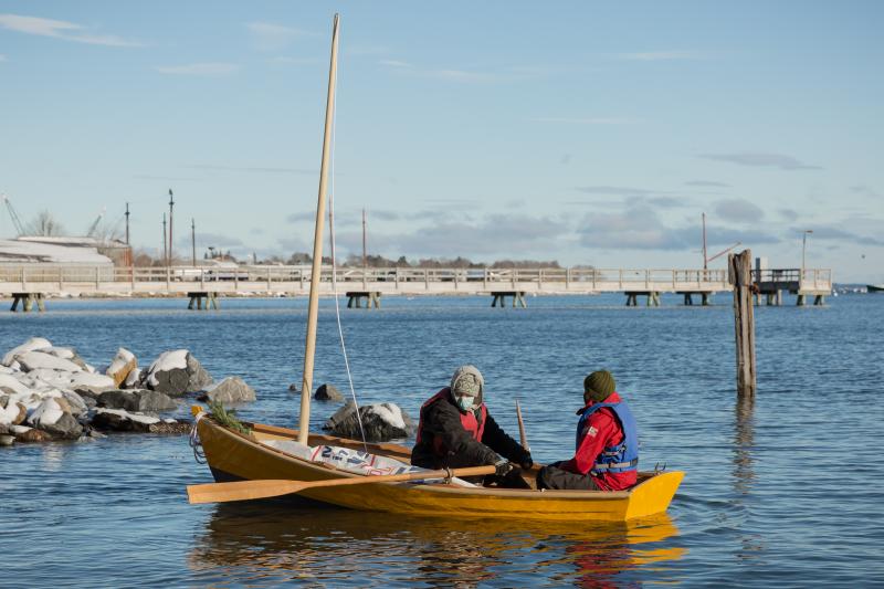 Tabitha rowing the boat she built with 9-month apprentice Tyler Kellen on launch day in December 2020. Tabitha and Tyler worked so rapidly that they had time to build oars and a sailing rig for their Susan skiff. (Photo by Erin Tokarz)