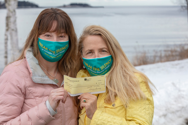Sarah McLean, Finding Our Voices board director, and Patrisha McLean, founder/president, with a $50,000 check to Finding Our Voices from the Sunshine Lady Foundation. Other board members of the grassroots non-profit organization breaking the silence of domestic abuse are Nicole Gogan and Jon Wilson. (Photo courtesy Peter Ralston)