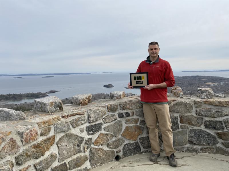 Peter Rollins, Mt. Battie Star volunteer, is shown accepting the Beacon Award