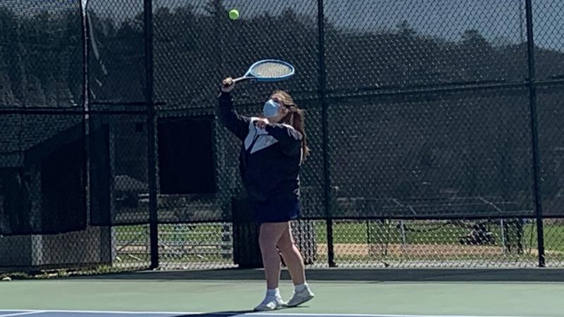 Della Hahn hits a serve in her first varsity doubles victory April 23 with her partner Kylie Brown versus Medomak Valley. Hahn and Brown lost the first set before rallying to win the final two. BILL PEARSON/Boothbay Register