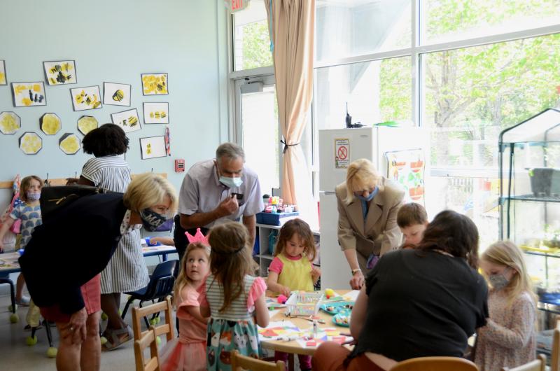 Rep. Vicki Doudera, D-Camden, Gov. Janet Mills, and Senator David Miramant, D-Camden, confer with a table of children about their projects. (Photo by Lynda Clancy)