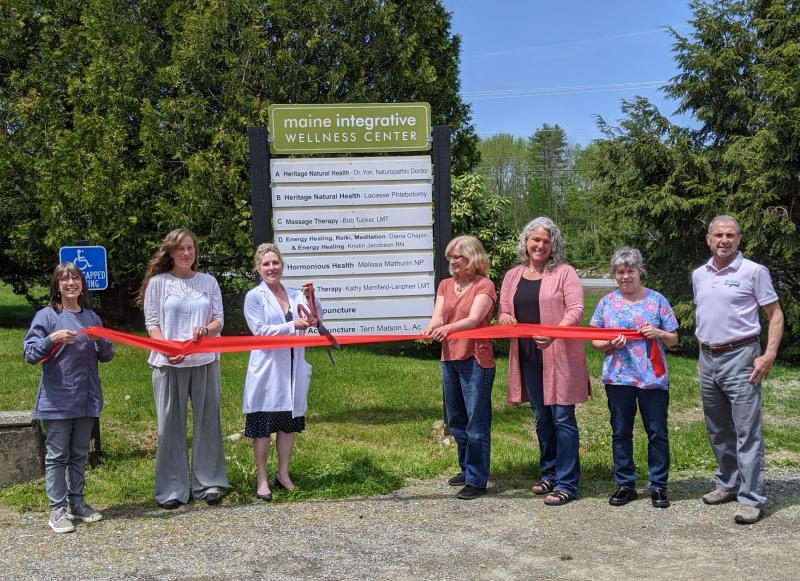 Melissa Mathurin NP of Hormonious Health (third from left)
celebrates her practice opening with Dr. Tamara Kennard, owner of the Maine Integrative Wellness Center (fourth from left), and Steve Ryan (far right) director of the Belfast Area Chamber of Commerce, at a recent ribbon cutting event. (Photo courtesy Belfast Area Chamber of Commerce)