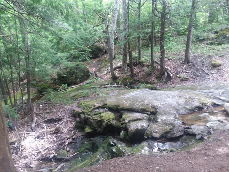 A stream running parallel to the trail becomes a waterfall. Photo by Kay Stephens