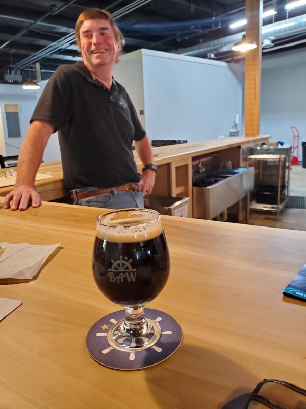 Co-owner Pepper Powers with an eight-ounce pour of Steel Cutter Stout. Photo courtesy of Stan Rintz