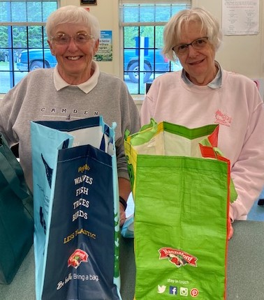 Camden Area Christian Food Pantry volunteers Faith Vautour (L) and Penny Baum (R) get ready to begin filling client orders.