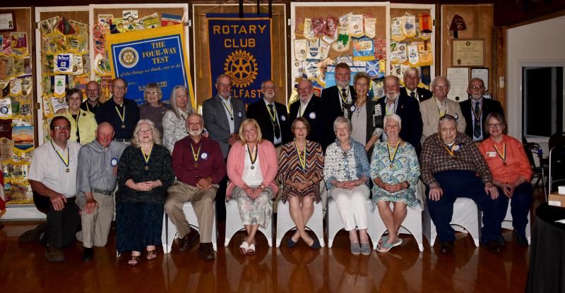 Two dozen Belfast Rotary Paul Harris Fellows, including newest members Mickey Sirota and Dr. Michelle Morrow (front row, 4th and 5th from left), posed for a group photograph at the Club’s 96th annual dinner on June 23. (Photo courtesy Mary Carthage/Belfast Rotary Club)