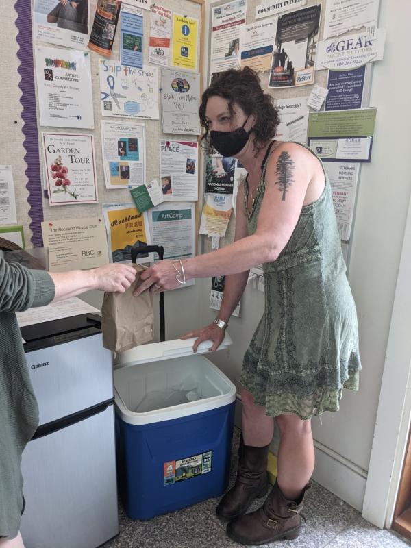 Rockland Library showing librarian Jessica Blanchard handing out a meal. Photo courtesy Rockland Public Library