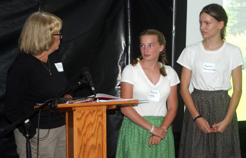Jean McKay talks to local students and Living History actors Hannah Hills, center, and Beatrix Beatrix Recoing-Tallen, in costume. STEVE EDWARDS/Boothbay Register