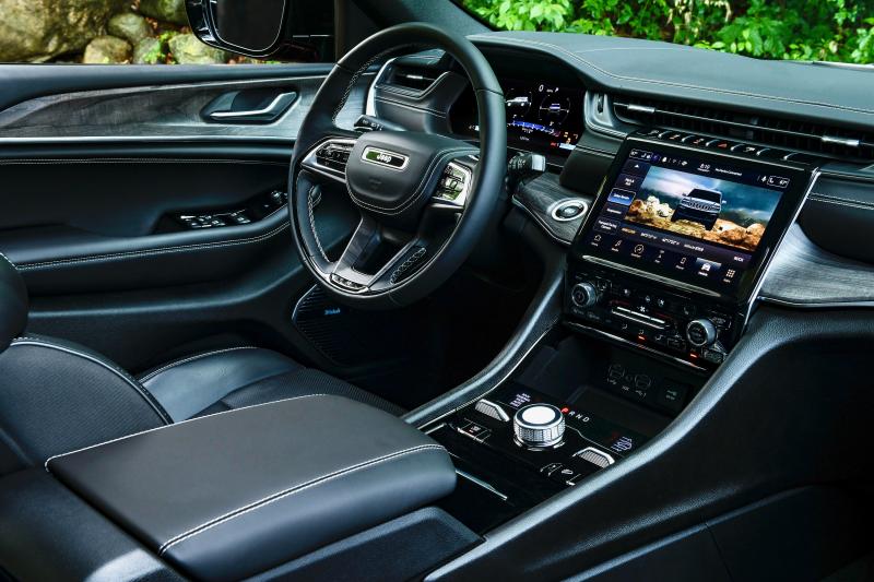 The Grand Cherokee L Overland interior in Global Black. Note the drive-mode and air-suspension adjusters to either side of the gear selector knob on the console.