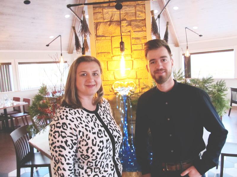 Oana Manton, co-owner with Manager John Sullivan in the warm dining space. Photo by Kay Stephens