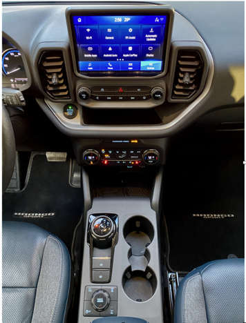 The Bronco Sport’s 8-speed automatic transmission has a rotary dial. The GOAT—Goes Over Any Terrain—selector offers Sand, Slippery, Sport, Eco or Normal drive modes; the Badlands package adds Mud/Ruts and Rock Crawl.