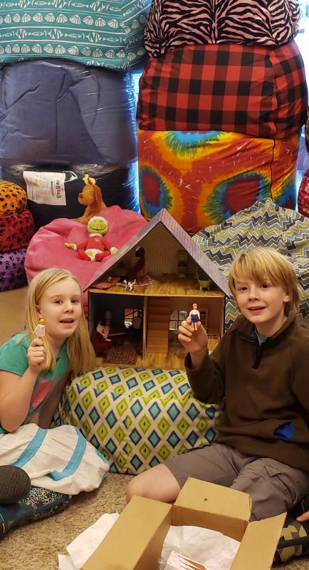 Avi and Cole with the dollhouse back over in their father’s shop. Photo courtesy Matt Lecher.