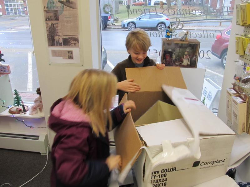 Avonlea Lecher, 10 and her brother Cole Lecher, 12, open a surprise post-Christmas present organized by their father, Matt and Jamie’s Miniatures owner Jamie Lucas. Photo by Kay Stephens