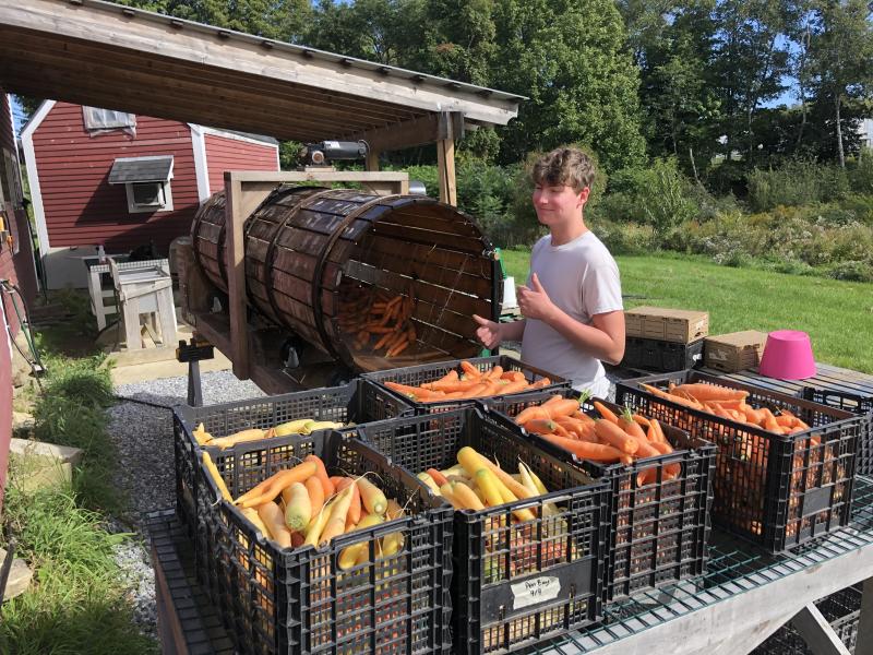 2021 Summer Teen Ag Crew Leader, Cole Thompson, operating the rootwasher at Erickson Fields. (Photo courtesy Maine Coast Heritage Trust)