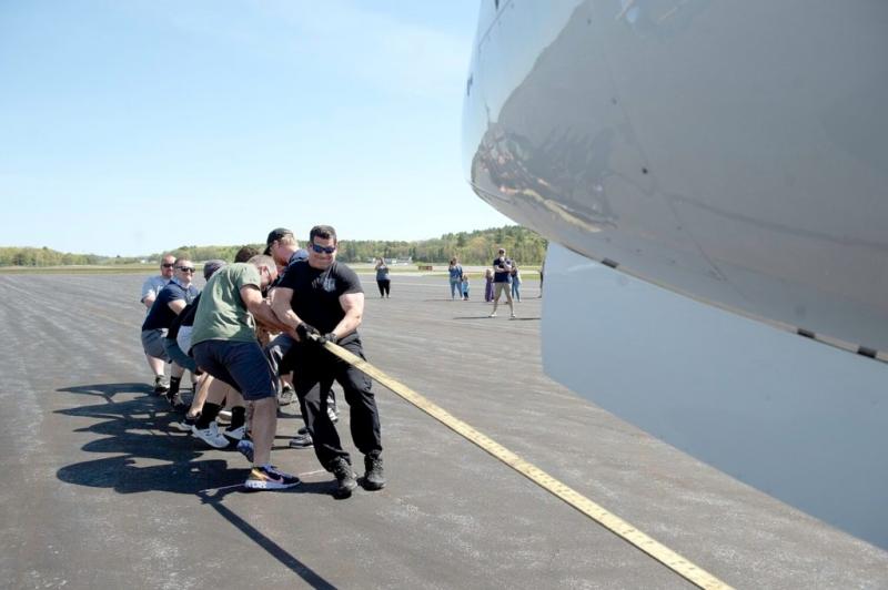Lt. Dave St. Pierre of the Lewiston Police Department helps his colleagues pull a 31,000 pound jet in fastest time to win last year’s Big Brother Big Sisters of Mid-Maine Plane Pull. (Photo by Daryn Slover/Sun Journal)