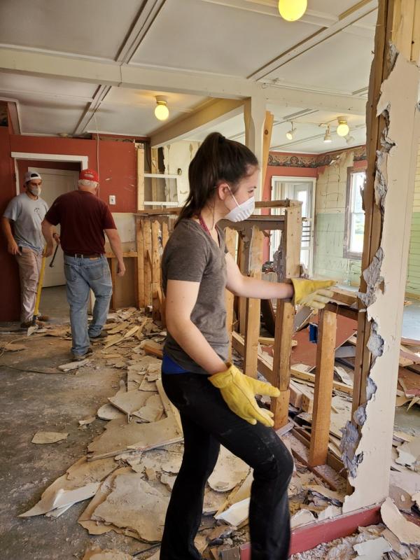 Christopher works on a wall during the renovations. (Photo by Victoria Christopher)