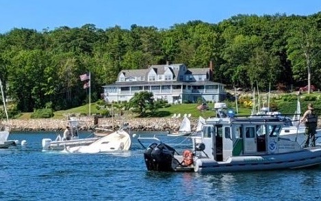 The Border Patrol in its pontoon; Camden Harbor Master Steve Pixley in the pump out boat, and Brad Scott aboard the Web, in the background, fight to get the Bandwagon to shore. (Photo courtesy Schooner Surprise)