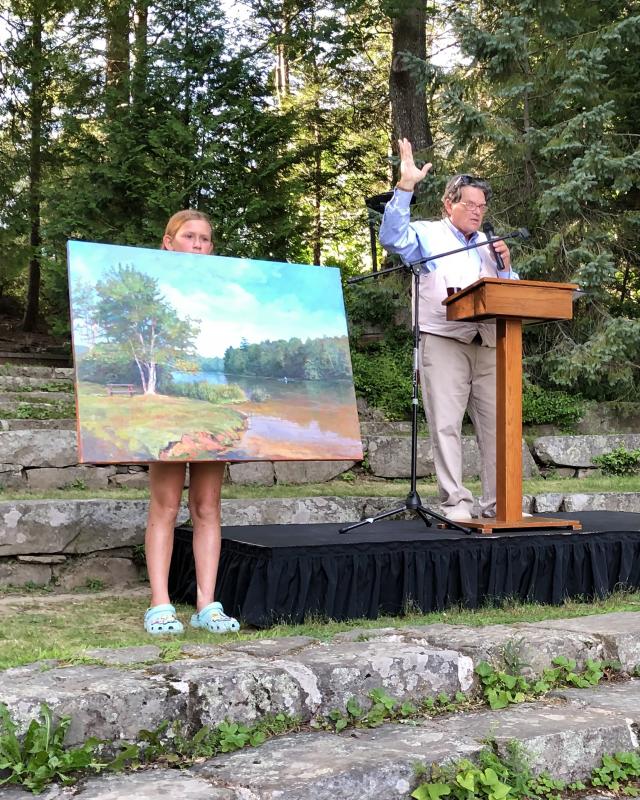 Kaja Veilleux auctioned "Shirttail Point Park" by Peter Yesis, which drew the afternoon's highest bid of $9,500. (Photo courtesy Camden Public Library)
