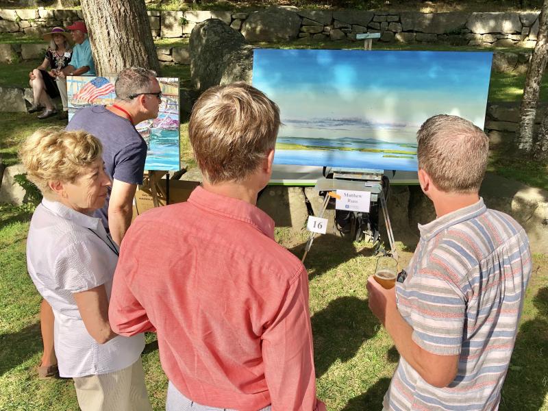 The public admired the exhibit of plein-air paintings and mingled with the artists at the reception in the Camden Amphitheatre. (Photo courtesy Camden Public Library)