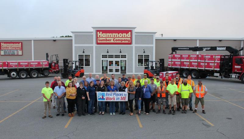 Hammond Lumber Company employees hold a 2022 Best Places to Work in Maine banner. The 2022 Best Places to Work in Maine list is made up of 100 companies in three size categories: 34 small winners (15- 49 U.S. employees), 45 medium winners (50-249 U.S. employees) and 21 large winners (250+ U.S. employees). (Photo courtesy Hammond Lumber Company)