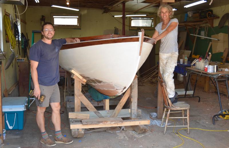 Cody Smith and Lisa Morgan, with ‘Wren’, finishing her restoration before a Sept. 15 launch. (Photo by Lynda Clancy)