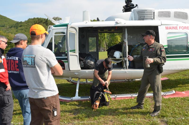 Chief Forest Ranger Pilot John Crowley and District Forest Ranger Scott Maddox spent a few hours Sunday, Sept. 18, with the Camden Fire Dept. and members of the Coastal Maine Search and Rescue explaining how they will assist local fire departments with lifting the injured or sick from remote locations and transfer them to safe landing zones, and waiting ambulances. (Photo by Lynda Clancy)