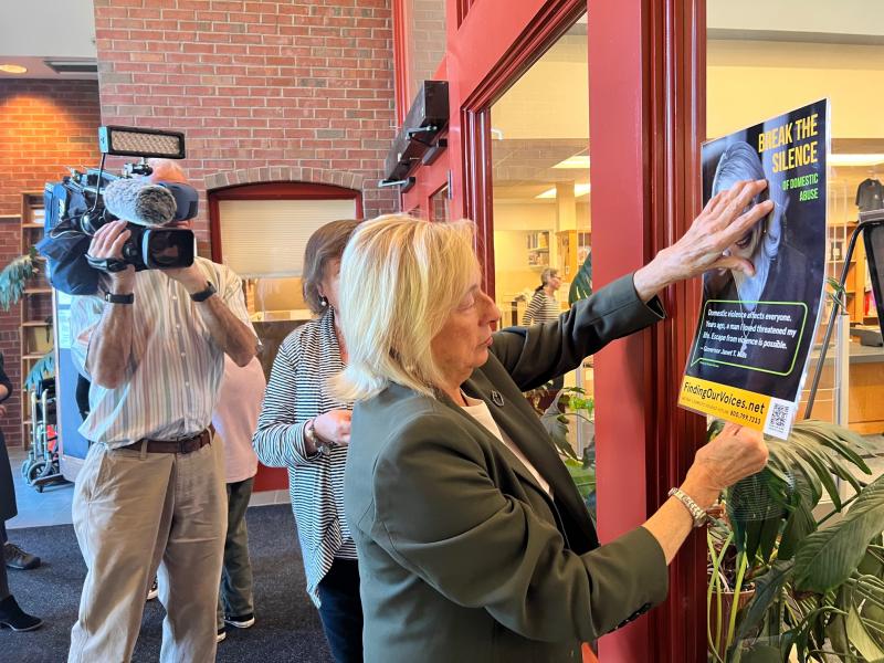 Governor Janet Mills helped to hang the Finding Our Voices exhibit of posters at the Scarborough Public Library, Sept. 29, 2022, launching Domestic Abuse Awareness Month, along with students from Scarborough High School and the library's Teen Advisory Board. (Photo courtesy Patrisha McLean)