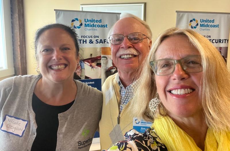 Nicole Gogan, Finding Our Voices board treasurer and owner of Superior Restoration, and Patrisha McLean, the group’s founder and president with Jim Hengerer, United Midcoast Charities vice chair and grants committee chair. (Photo courtesy Finding Our Voices)