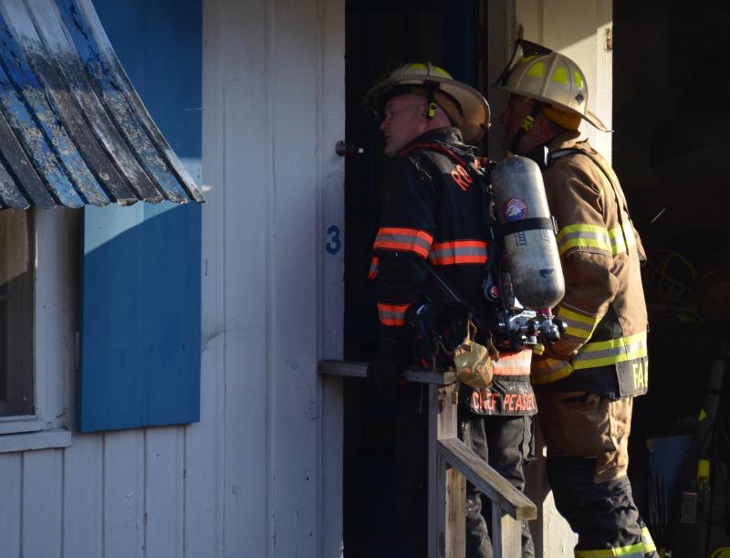 Rockport Fire Chief Jason Peasley and Camden Fire Chief Chris Farley assess the inside of the motel building. (Photo by Lynda Clancy)