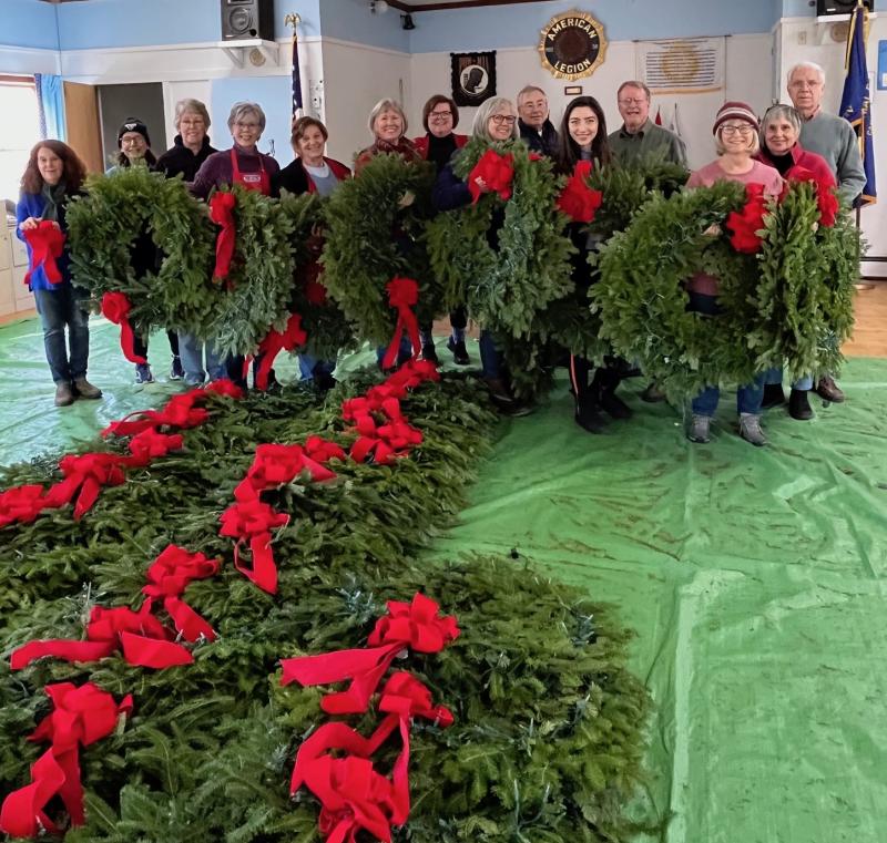 Ninety-eight fresh balsam wreaths are completed with handmade crimson felt bows and strings of warm white lights for hanging downtown by Camden Garden Club members. (Photo courtesy Camden Garden Club)