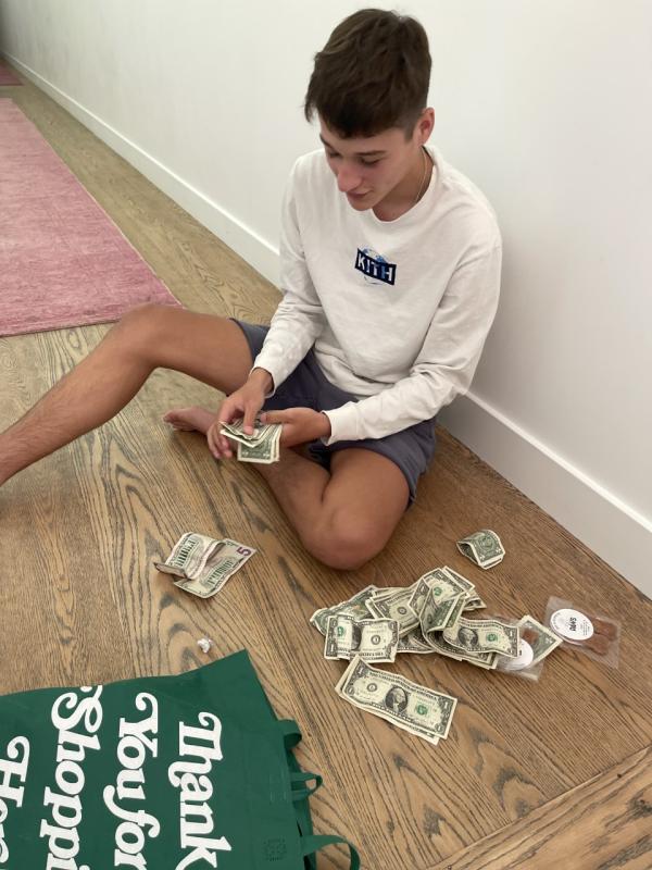 Finn Bennett counting donations made to PAWS in exchange for free homemade dog bones. (Photo courtesy Rachael Bennett)