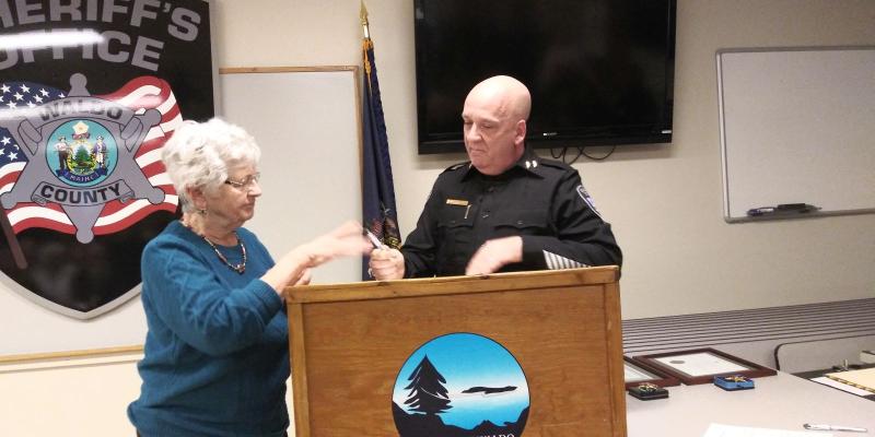 Sheriff Jason Trundy is sworn in as sheriff by Irene Blood, who worked with District Court for 30 years before retiring. Blood also swore in former Sheriffs Scott Story and Jeffrey Trafton. (photo by Erica Thoms)